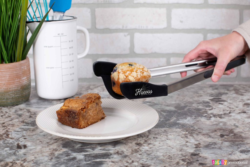 custom tongs picking up a muffin