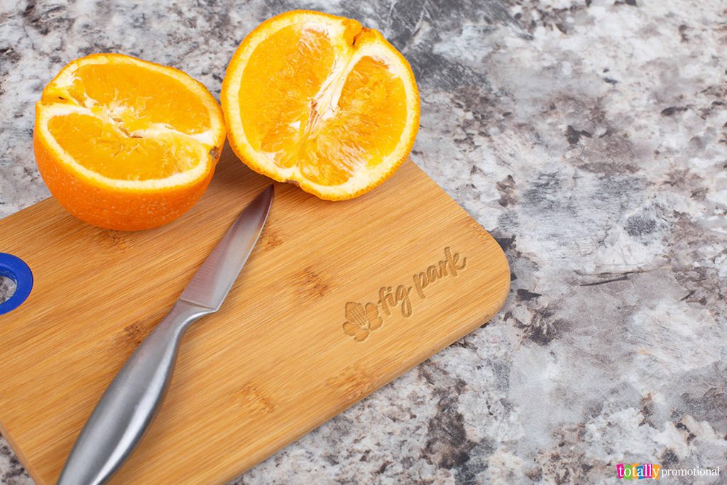 custom cutting board with a sliced orange atop it