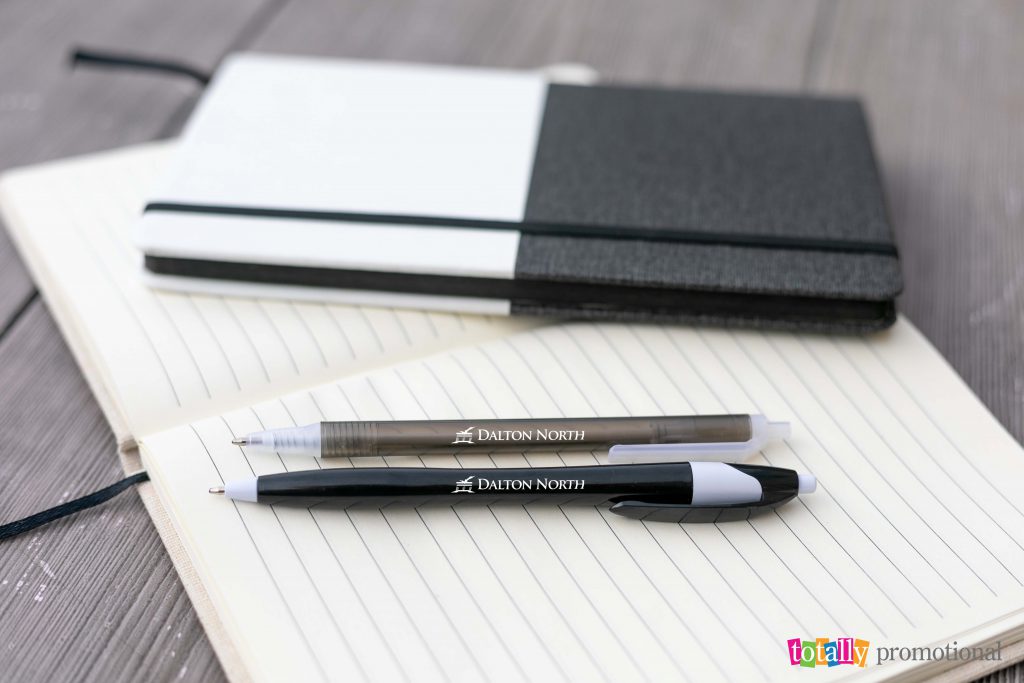 custom printed pens with business logo on notebook