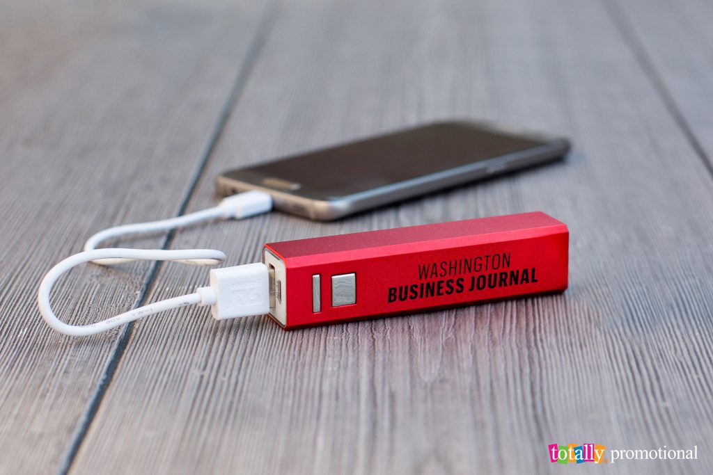 red power bank with custom logo charging a phone