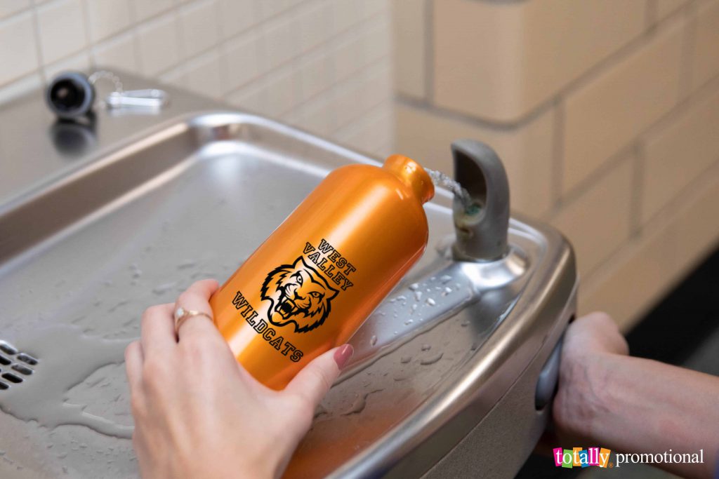 filling personalized metal sports bottle at drinking fountain
