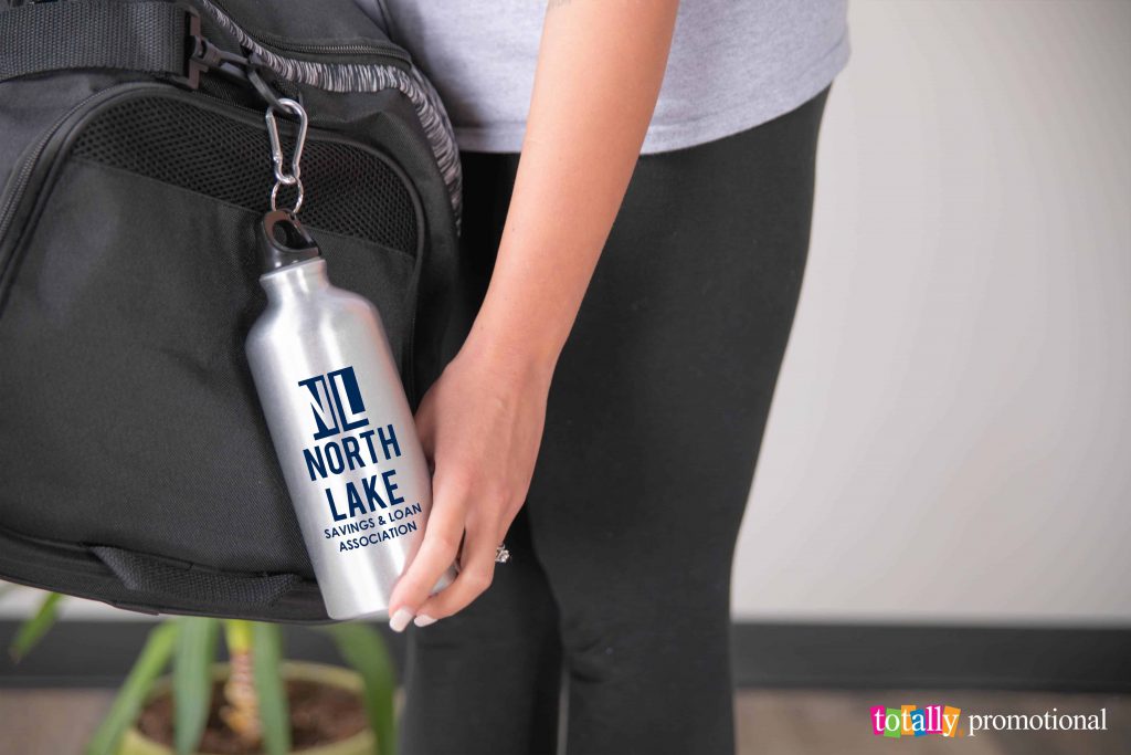 aluminum water bottle with a company logo hanging on a bookbag