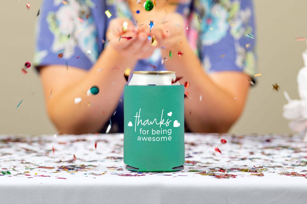 turquoise koozie with white imprint and confetti