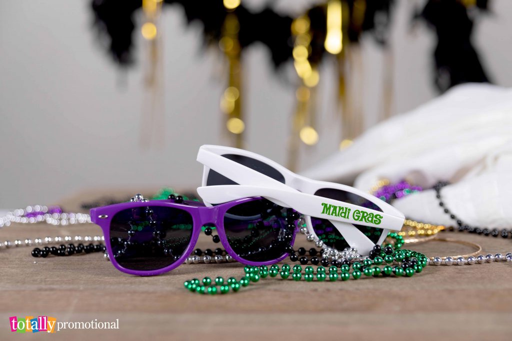 purple and white mardi gras themed sunglasses and beads