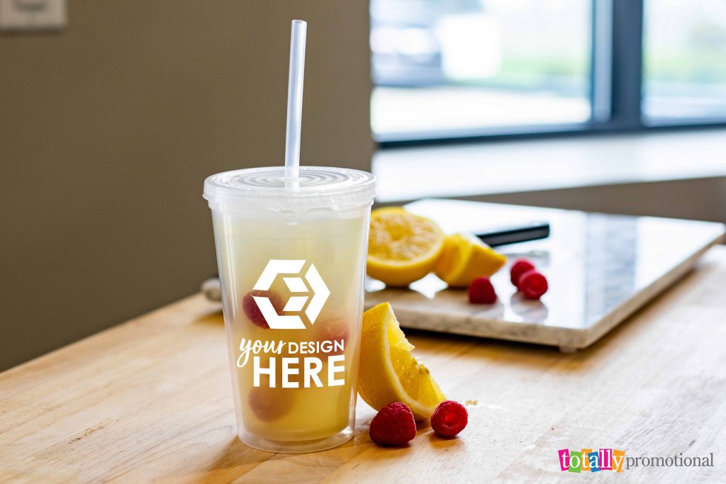 custom clear plastic tumbler on a table with fruit