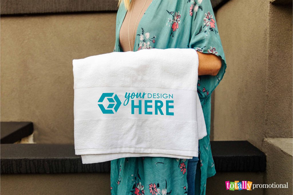 woman holding a custom printed beach towel