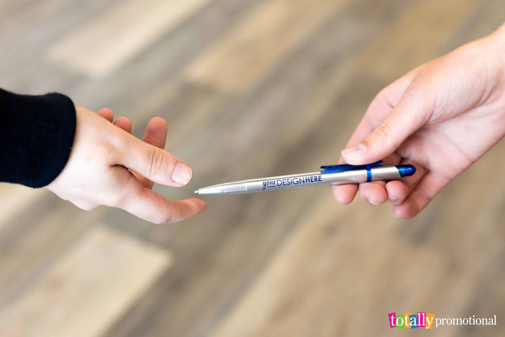 handing a custom pen to someone else