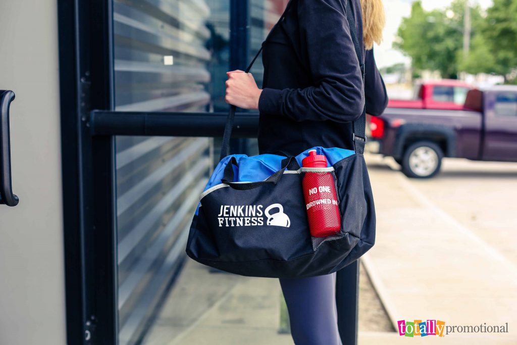 customized duffel bag and water bottle with gym logos