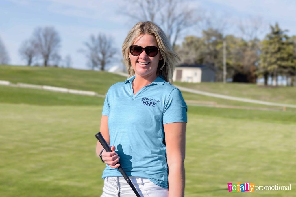 woman wearing a customized polo while playing golf