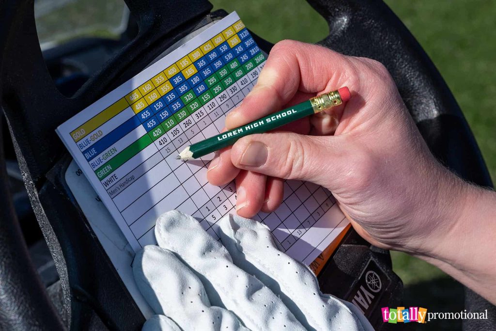 customized golf pencils with a scorecard in a golf cart