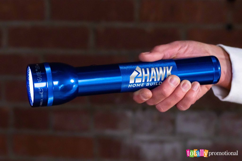 person holding a promotional flashlight