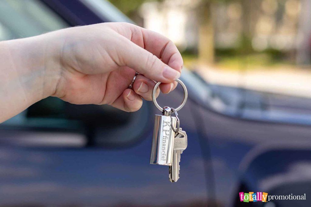 woman holding car keys with a customized keychain