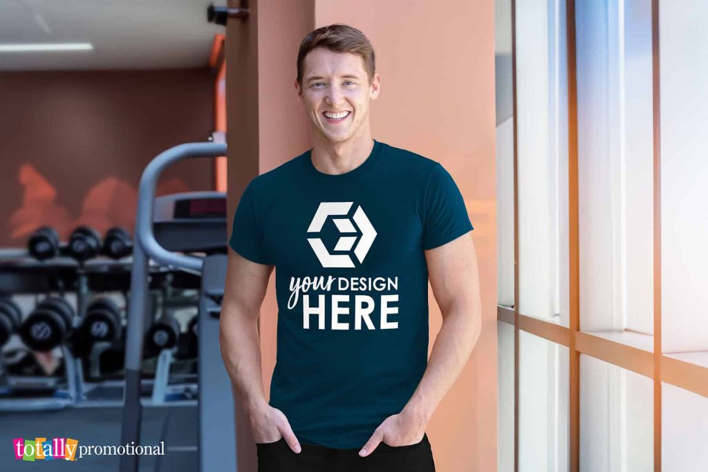 man wearing a customizable performance t-shirt at the gym