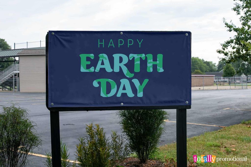 happy earth day banner outside a park