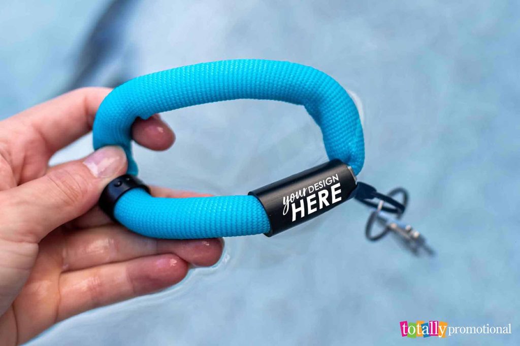 person holding a customizable floating wrist keychain