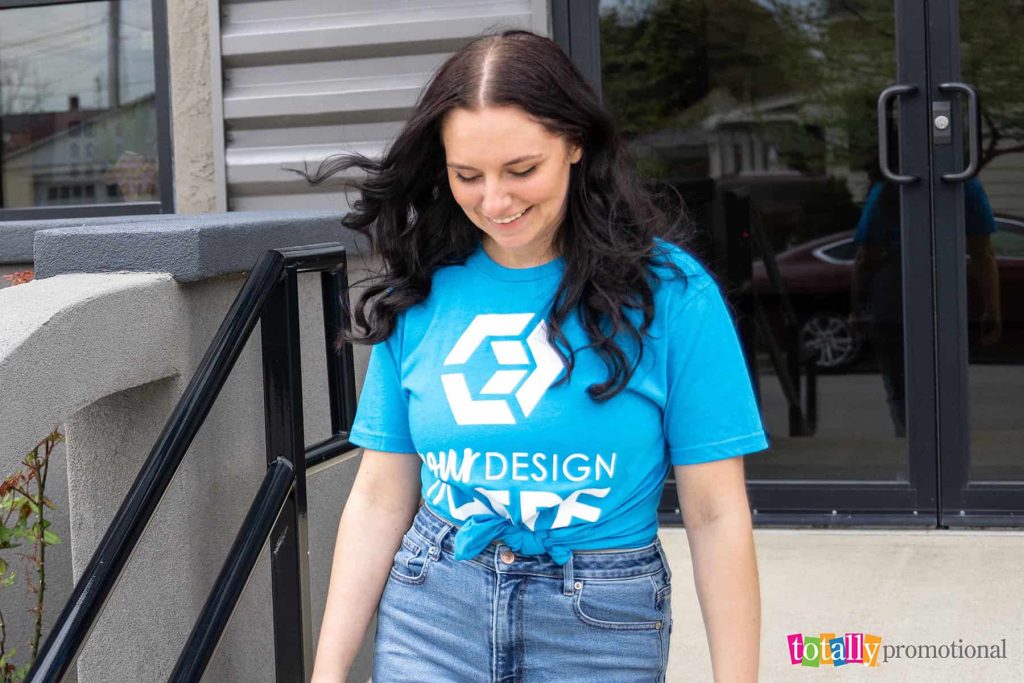 woman wearing a customizable t-shirt outside an office building